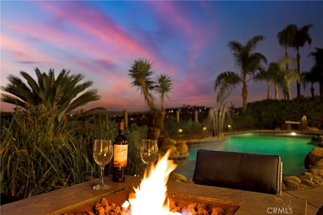 pool with an outdoor fire pit