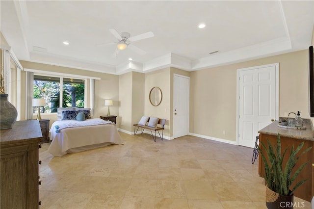 bedroom featuring crown molding, a raised ceiling, and baseboards