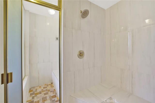 full bathroom featuring tile walls and tiled shower