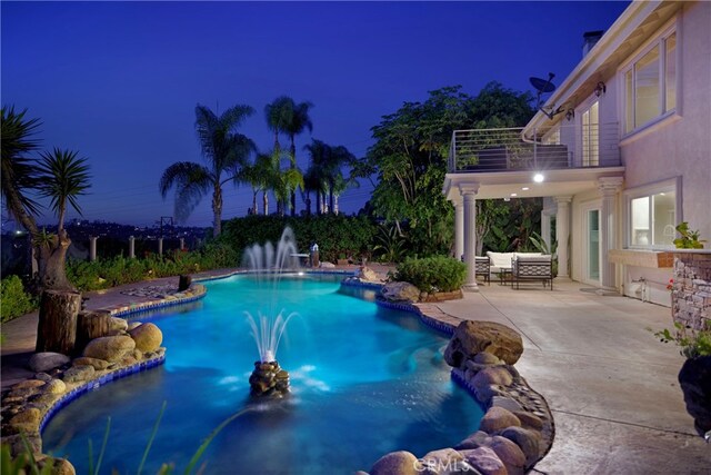 pool at twilight with an outdoor pool, an outdoor living space, and a patio