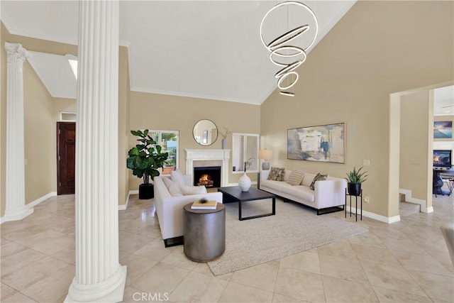 living room with high vaulted ceiling, decorative columns, and a premium fireplace