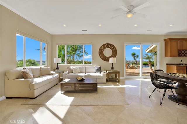 living room featuring ceiling fan, recessed lighting, visible vents, baseboards, and crown molding