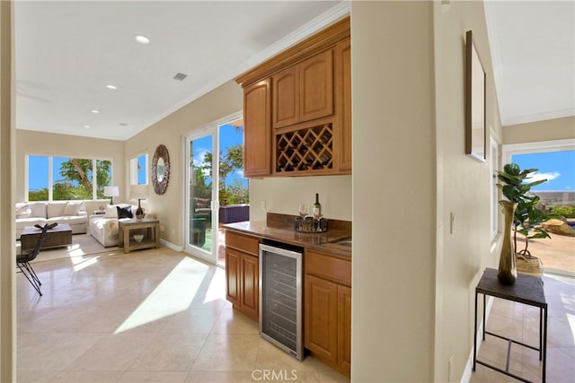 bar with beverage cooler, a bar, ornamental molding, and recessed lighting