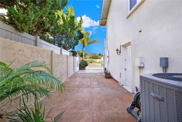 exterior space with central AC unit and fence