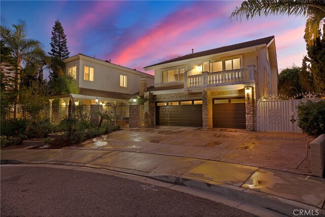 view of front of home featuring a garage and a balcony