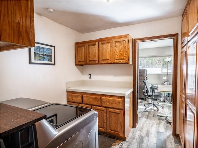 kitchen with stainless steel range and hardwood / wood-style floors