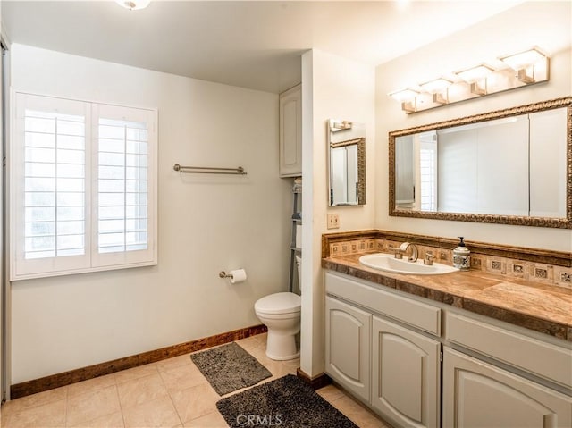 bathroom with tile patterned floors, vanity, and toilet