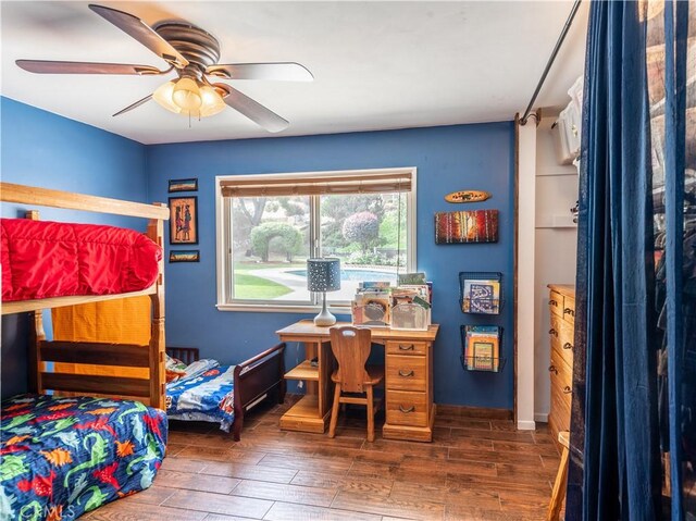 bedroom featuring ceiling fan and dark wood-type flooring