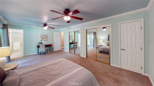 carpeted bedroom featuring multiple closets, ensuite bath, crown molding, and ceiling fan