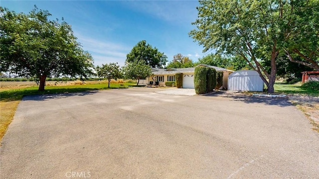 ranch-style home featuring an attached garage and driveway