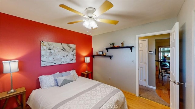 bedroom with ceiling fan and light hardwood / wood-style flooring