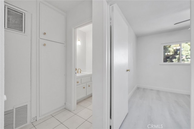 hall featuring light tile patterned floors