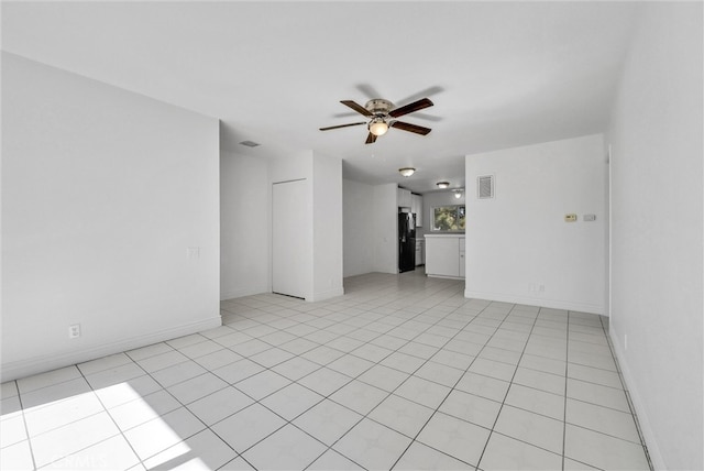 tiled empty room with ceiling fan