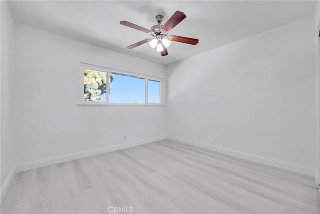 empty room with light hardwood / wood-style flooring and ceiling fan