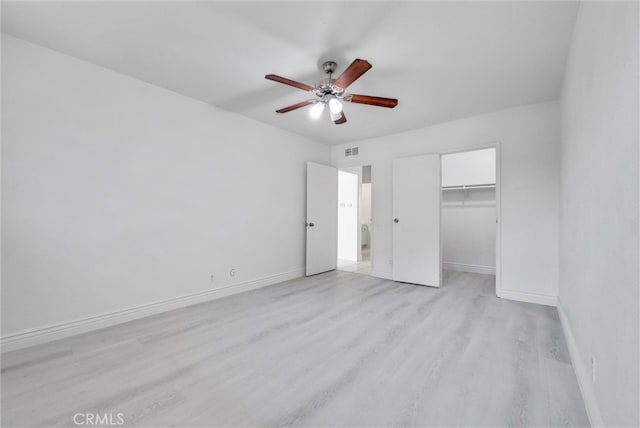 unfurnished bedroom with a closet, light hardwood / wood-style floors, and ceiling fan