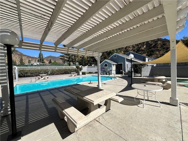 view of pool featuring a pergola, a patio area, and a mountain view