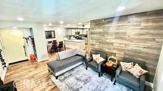 living room with wood walls and hardwood / wood-style floors