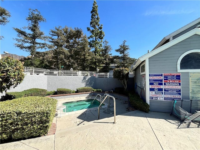 view of pool with a patio area and a community hot tub