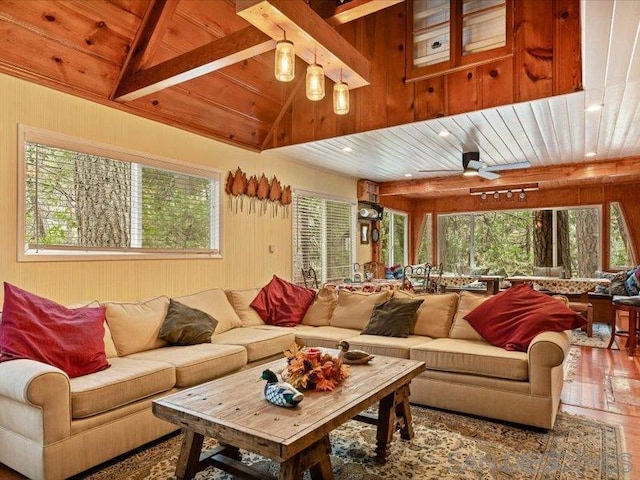 living room featuring ceiling fan, wooden ceiling, hardwood / wood-style floors, vaulted ceiling with beams, and wood walls