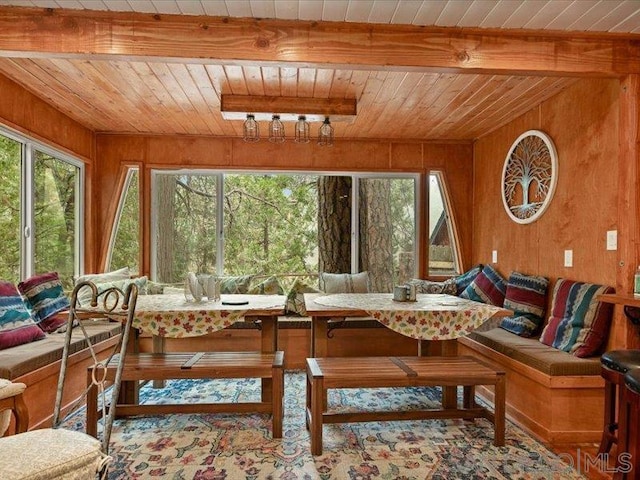 sunroom featuring beamed ceiling, breakfast area, and wooden ceiling