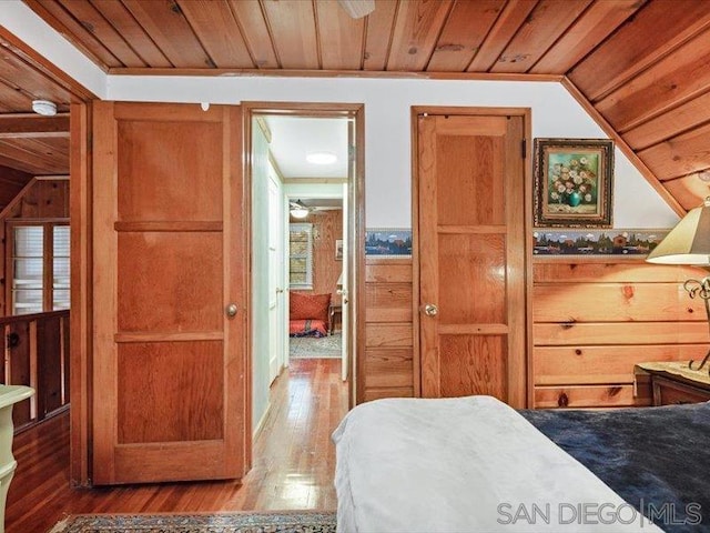 bedroom featuring wooden ceiling, wood-type flooring, and vaulted ceiling