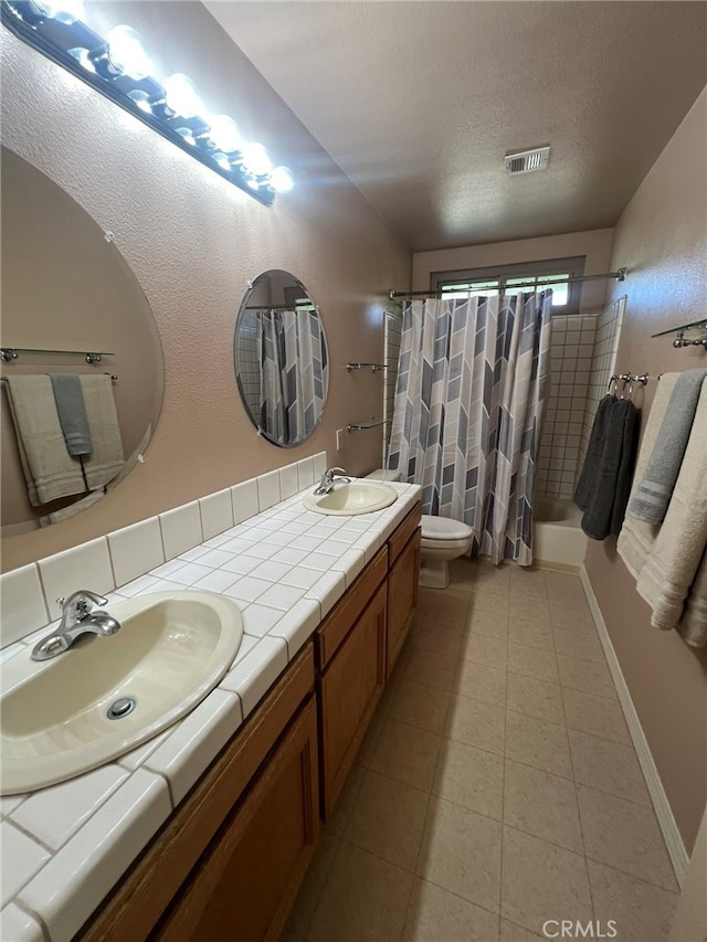 full bathroom with vanity, toilet, a textured ceiling, and shower / tub combo with curtain