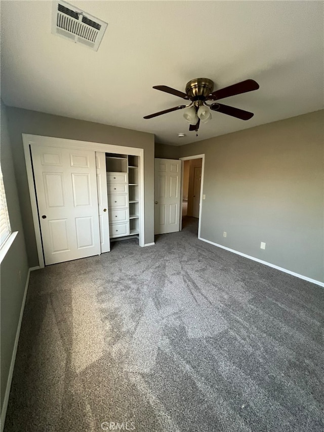 unfurnished bedroom featuring ceiling fan and dark carpet