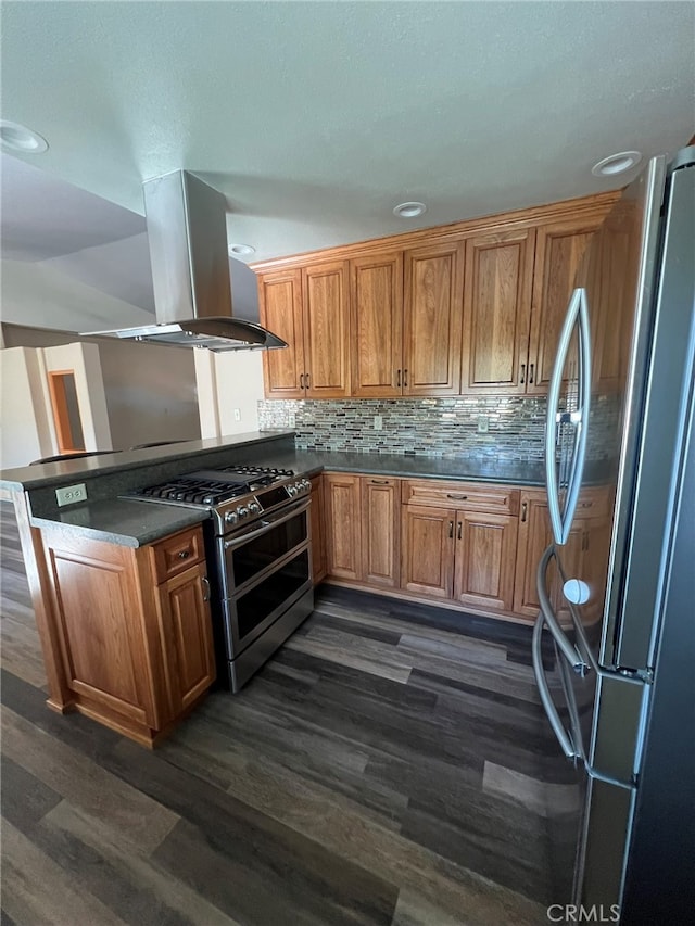 kitchen featuring kitchen peninsula, decorative backsplash, island exhaust hood, dark hardwood / wood-style flooring, and stainless steel appliances