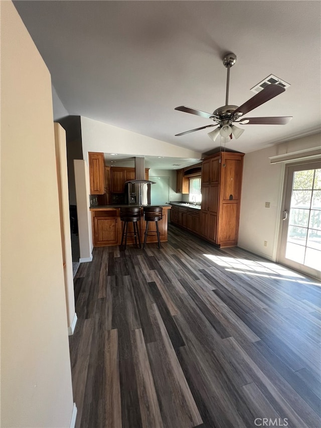 unfurnished living room with ceiling fan and dark hardwood / wood-style floors