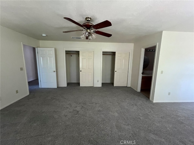 unfurnished bedroom with a textured ceiling, dark carpet, and ceiling fan