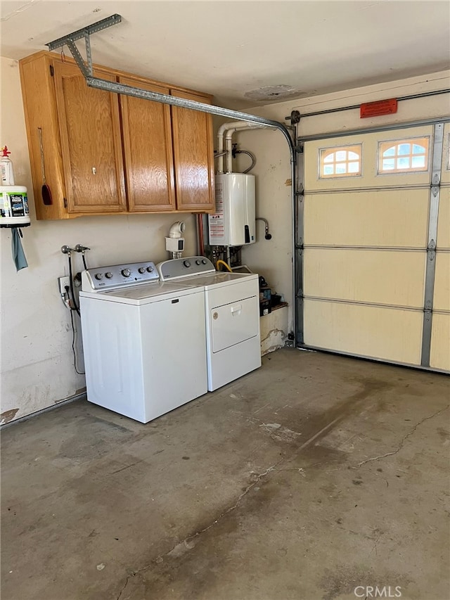 garage featuring water heater and separate washer and dryer