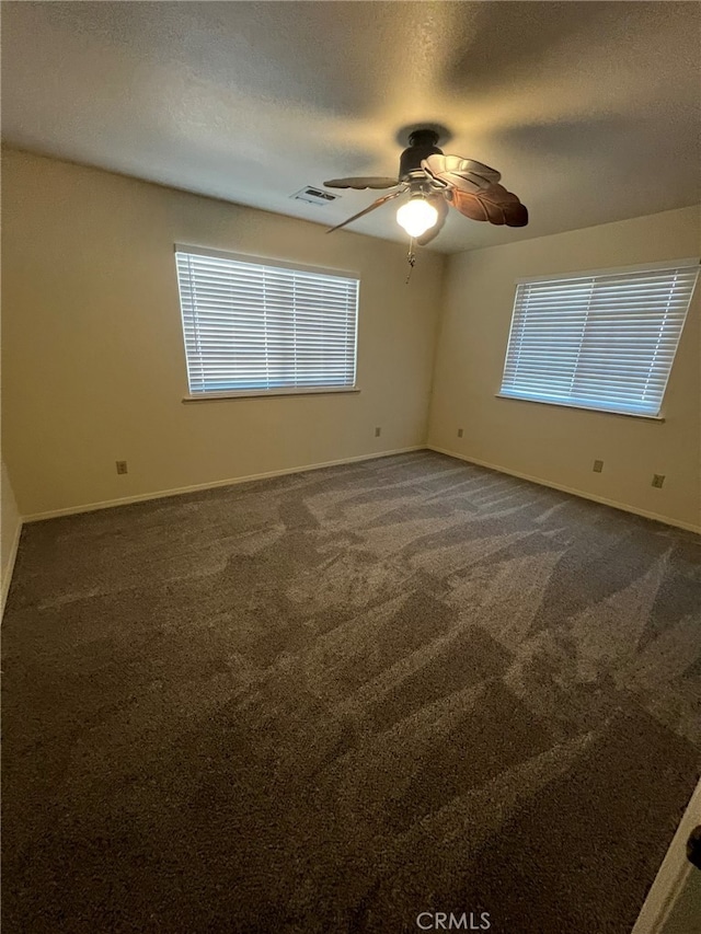 carpeted empty room with a textured ceiling and ceiling fan
