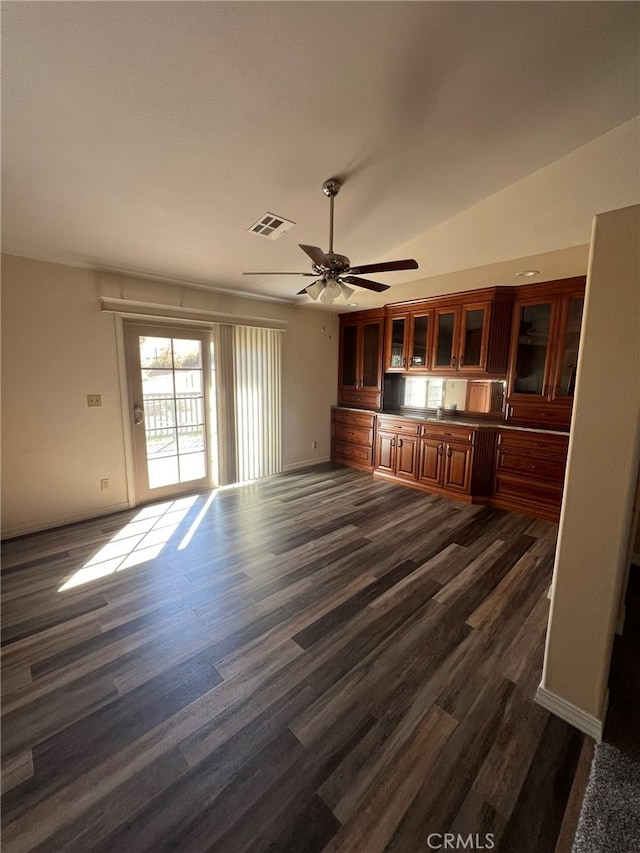 unfurnished living room featuring lofted ceiling, ceiling fan, and dark hardwood / wood-style flooring
