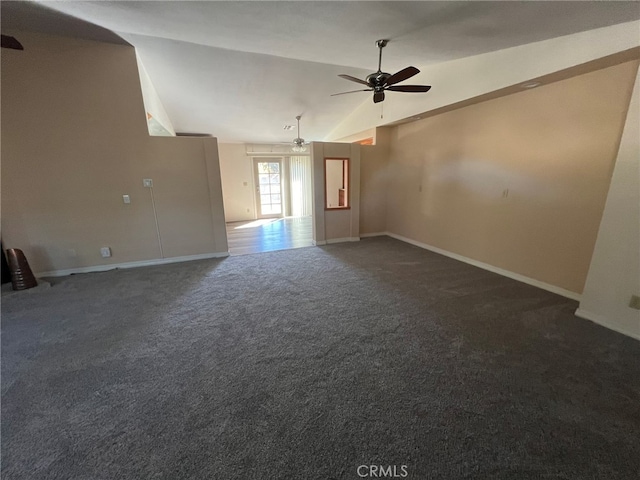 empty room featuring high vaulted ceiling, dark carpet, and ceiling fan