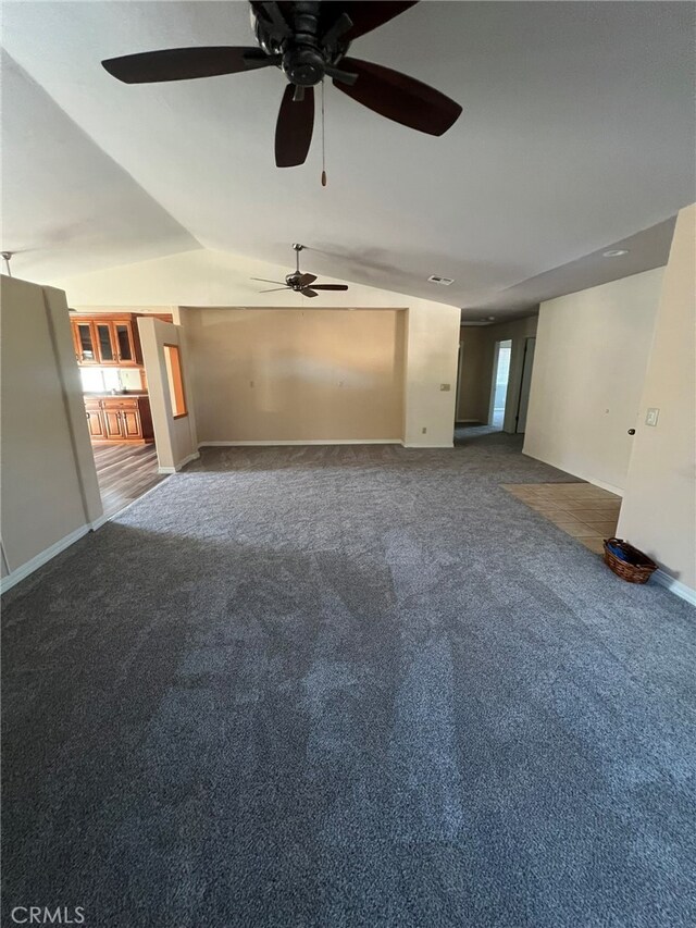 unfurnished living room featuring carpet floors, ceiling fan, and vaulted ceiling