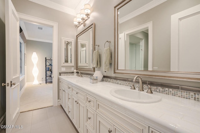 bathroom with vanity, ornamental molding, and tile patterned flooring