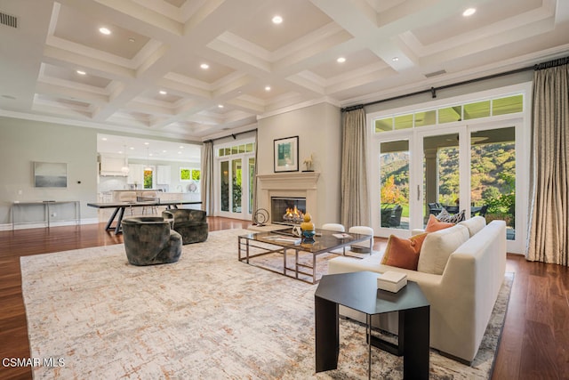 living room with dark wood-type flooring, plenty of natural light, and coffered ceiling