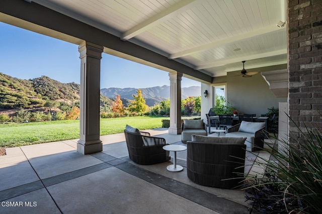 view of patio with ceiling fan, outdoor lounge area, and a mountain view