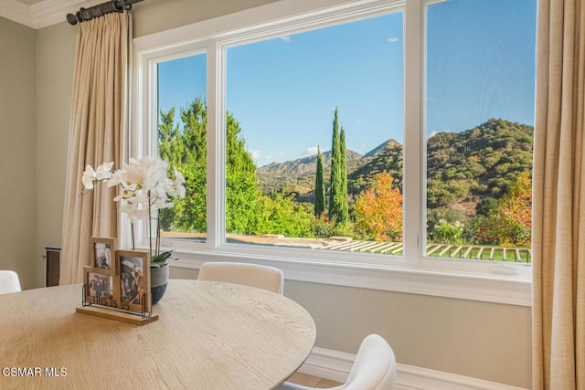 dining room featuring a healthy amount of sunlight and a mountain view