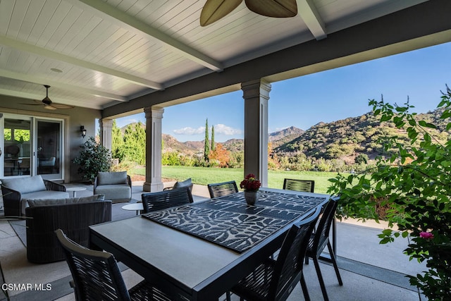 view of patio / terrace featuring ceiling fan, a mountain view, and an outdoor living space