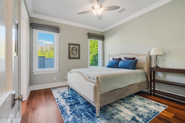 bedroom with ceiling fan, dark wood-type flooring, and crown molding