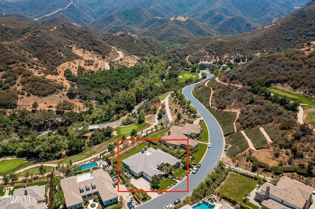 birds eye view of property with a mountain view