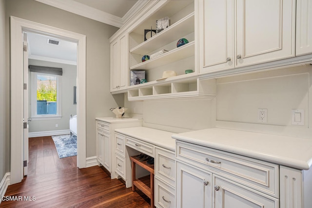 bar with white cabinets, dark wood-type flooring, and ornamental molding