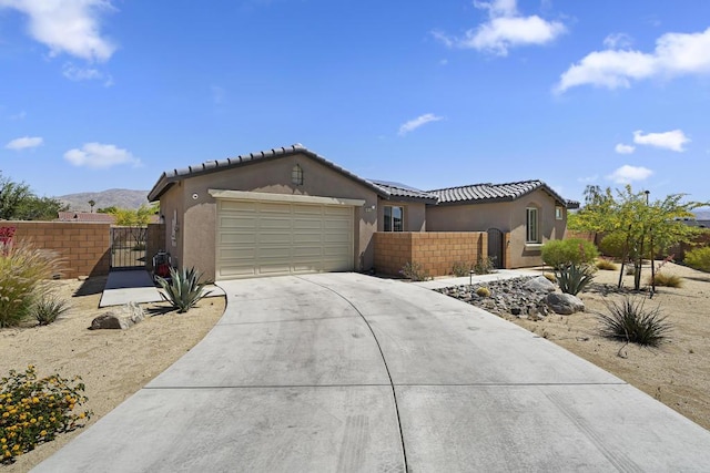 view of front of house with a mountain view and a garage