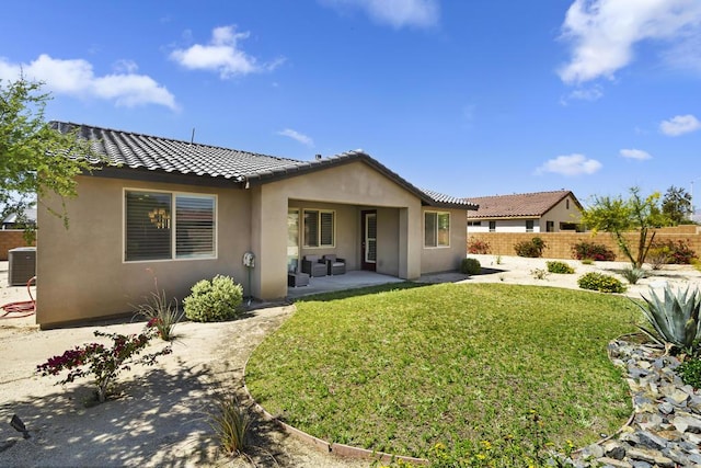 rear view of house featuring central AC, a yard, and a patio