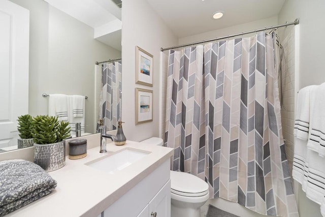 bathroom featuring vanity, toilet, and curtained shower