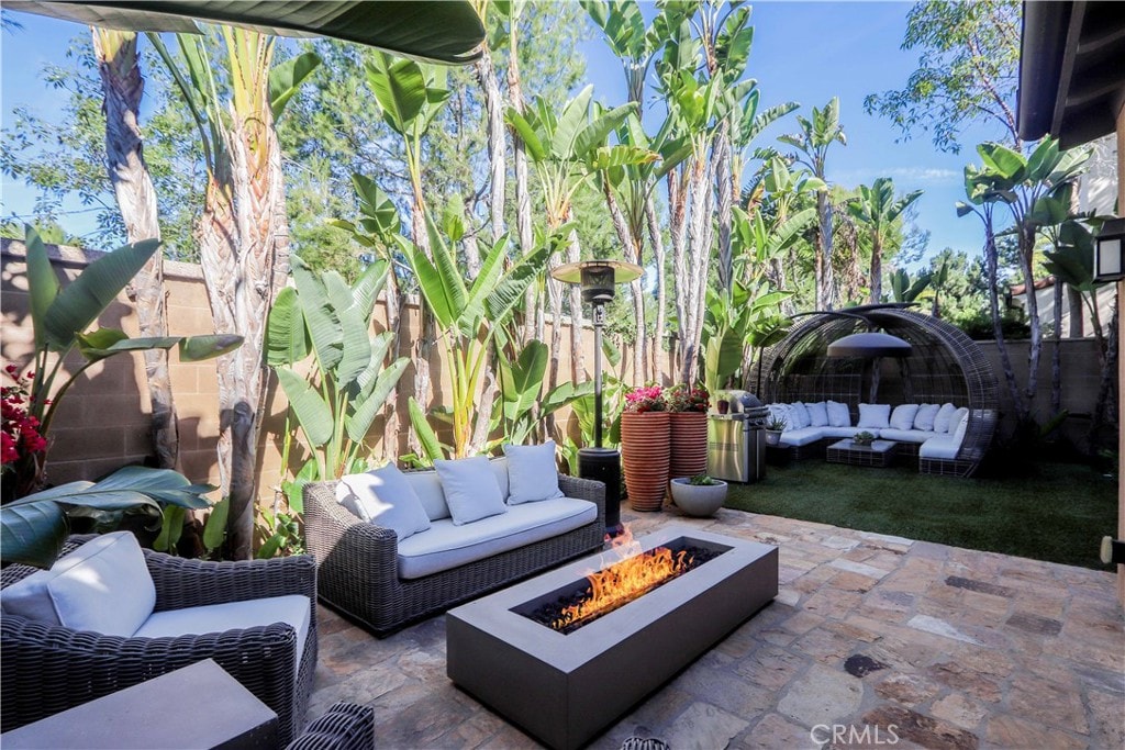 view of patio / terrace with an outdoor living space with a fire pit