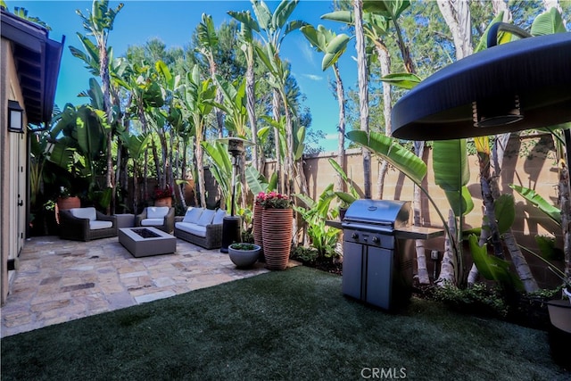 view of patio / terrace featuring an outdoor living space with a fire pit and grilling area