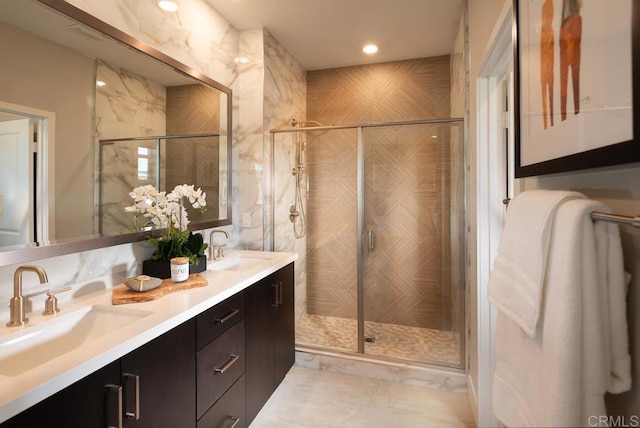 bathroom featuring vanity and a shower with shower door