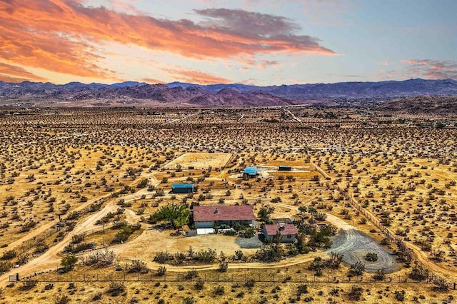 aerial view at dusk featuring a mountain view